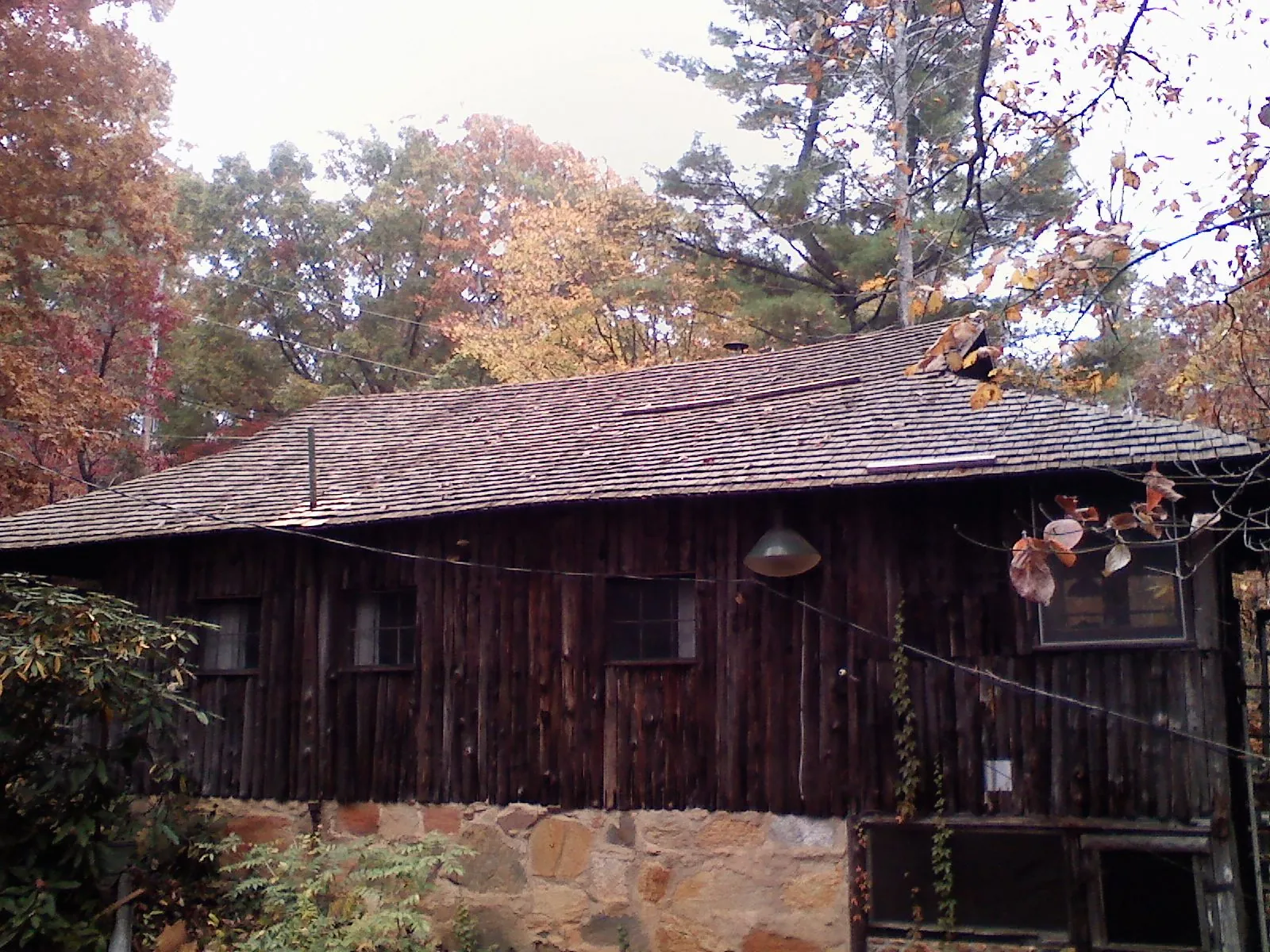 Weathered wood shake roof on a rustic board sided cabin in New Braunfels